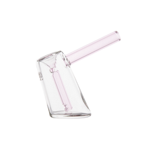 The MJ Arsenal Fulcrum Bubbler, made from clear borosilicate glass, has a cylindrical base and an angled light pink mouthpiece, shown against a white background.