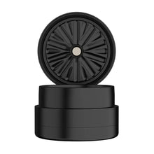A matte black, cylindrical Flower Mill 2.5" Next Gen Standard Grinder with the top lid removed and standing upright, revealing sharp circularly arranged teeth inside its round aluminum body.