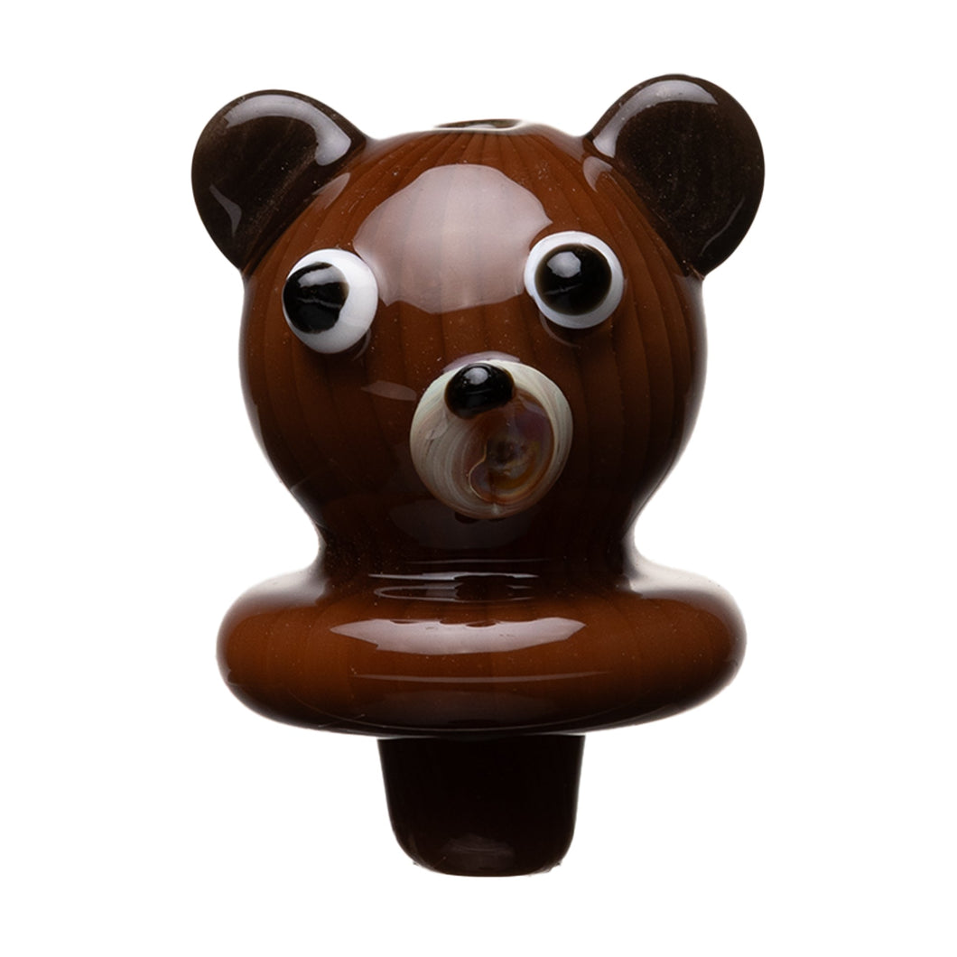The Human Grade Bear Carb Cap is a small, glossy brown accessory shaped like a bear’s head with exaggerated eyes and ears, crafted from glass or ceramic, and resembles a 510 vape battery with Type-C charging. Shown isolated on a white background.