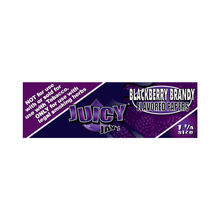 A rectangular label for Juicy Jay's Flavored Papers, Blackberry Brandy 1 1/4 size, in purple and black, displays tobacco warnings and showcases their triple-dipped flavoring system for enhanced taste with legal smoking herbs.