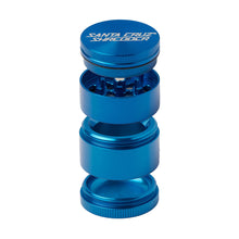 The Santa Cruz Shredder Small 4-Piece Grinder, shown in blue anodized aluminum, features four stackable compartments—lid, grinding teeth, mesh sifter, and collection chamber—displayed separated and aligned vertically.