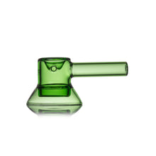 The MJ Arsenal Grotto Glass Pipe is a modern, minimalist hand pipe made from green borosilicate glass, featuring a cylindrical mouthpiece, wide flat base, and sleek lines set against a clean white background.