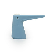 The SOFTGLASS PIER BUBBLER is a modern, minimalist blue watering can with a long, narrow spout and an angular base inspired by borosilicate glass pipe design, displayed against a white background.