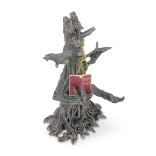 The Fantasy Tower Incense Burners feature a whimsical tree sculpture with a face and arms, holding an open red book titled Fairy Tales. Hand-painted resin captures textured bark and gnarled branches for unique charm and lively detail.