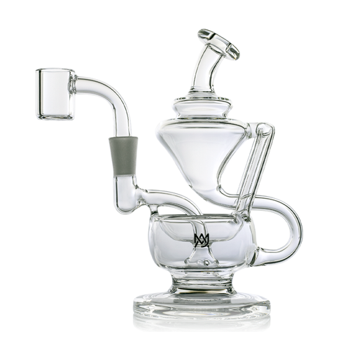 The MJ Arsenal Claude Mini Dab Rig is a clear glass recycler with multiple chambers, curved tubes, and a side handle. Its modern design provides secure stability on a flat base, making it ideal for smoking or vaporizing concentrates.