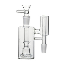 The Human Grade The Inverter Ash Catcher is a clear glass percolator attachment with a cylindrical main chamber, vertical side chamber, and angled mouthpiece, designed for 14mm water pipes or bongs.