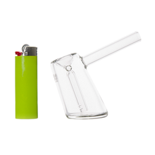 A green lighter and a small, clear MJ Arsenal Fulcrum Bubbler are displayed side by side on a white background.