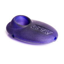 The Grav Sandblasted Pebble Spoon Pipe is a small, oval hand pipe with a bowl on one end, GRAV embossed on top, and a sleek matte finish, shown against a white background.