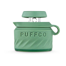 A green silicone container with lid and side loop, embossed with “PUFFCO,” is perfect for storing accessories like the Puffco Peak Pro Joystick Cap.