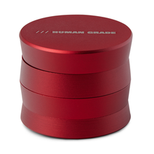 The Human Grade Grinder 3A (2" 4-Piece) is a shiny red cylindrical aluminum grinder with "HUMAN GRADE" engraved on the lid, featuring a two-part screw-top design.