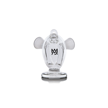 The MJ Arsenal Dubbler Original Double Bubbler is a clear borosilicate glass piece shaped like a stylized monkey with large round ears and a logo on its chest, shown against a plain white background.