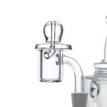 Close-up of the MJ Arsenal Flat Carb Cap, a clear glass attachment with a cylindrical chamber, designed for vaporizing concentrates. Shown on a plain white background. Compatible with quartz nails and essential oil attachments.