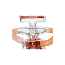 Close-up of the Calibear Twister Sweet Recycler Dab Rig, showcasing transparent and orange sections, a circular centerpiece, and curved orange handles on each side, all set against a white background.