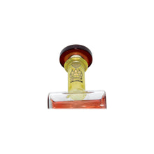 A close-up of the Calibear Twister Sweet Recycler Dab Rig shows a glass bottle with a brown cap, yellow neck, and bear paw logo with "CALIBEAR." The ergonomic base reveals amber liquid inside.