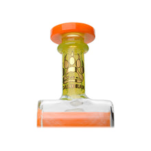 A clear Calibear Gusher Recycler Dual Percolator Dab Rig bottle with an orange rim and cap, featuring a yellow band on the neck with a black bear paw print and gold CALIBEAR lettering. The background is white.