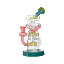 The Calibear Gusher Recycler Dual Percolator Dab Rig features intricate curves and chambers in green, pink, and yellow on a green circular base, shown isolated against a white background.