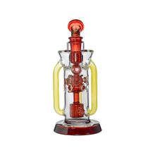 The Calibear Supercycler Recycler Dab Rig is a clear glass water pipe with red and yellow accents, a round base, two yellow side handles, intricate central chamber glasswork, and a recycler system for smoother hits.