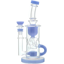 The Calibear Cascade Flower Of Life Klein Recycler Dab Rig has light blue accents on the base, mouthpiece, and bowl, plus a cylindrical chamber, side handle, curved neck, and a 14mm female joint.