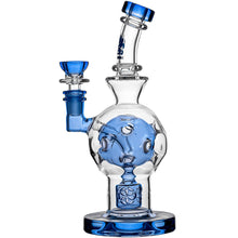 The Calibear Exosphere Seed Of Life Dab Rig is made of clear borosilicate glass with blue accents, features intricate internal glasswork, a Seed of Life percolator, and a curved neck.