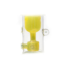 The Calibear Kickback Opal Incyler Dab Rig features a clear glass chamber, an internal yellow glass component with a cylindrical top, and a perforated seed of life percolator for efficient filtration or diffusion.