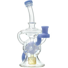 The Calibear Infinity Loop Seed Of Life Klein Recycler is a clear borosilicate glass water pipe with light blue accents, a curved neck, side handle, decorative chamber holes, and a gold-colored filter at the base.