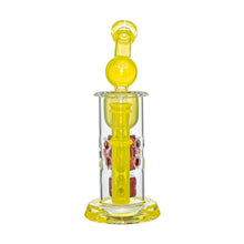The Calibear Seed Of Life Swiss Incycler Dab Rig features a yellow-tinted glass body, red interior accents, and a round chamber near the mouthpiece, standing upright on a clear and yellow base.