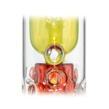 Close-up of the Calibear Seed Of Life Swiss Incycler Dab Rig with vibrant yellow and red sections, circular bubble-like accents, set against a white background.