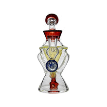 The Calibear Hourglass Marble Adorned Recycler Dab Rig features an hourglass-shaped glass bottle with red accents, clear and yellow sections, and a central blue marbled sphere, displayed against a white background.
