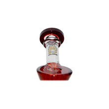 A close-up, upward view of a Calibear Hourglass Marble Adorned Recycler Dab Rig glass bottle filled with red liquid, featuring a gold paw print logo on the neck, set against a plain white background.