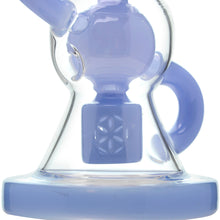 A close-up of the Calibear Vortex Seed Of Life Recycler Dab Rig, a translucent glass piece with a light blue hue, handle, smooth rounded shape, and an intricate geometric Seed of Life percolator at its base.
