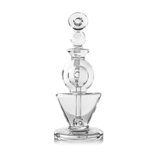 The MJ Arsenal Gemini Mini Dab Rig, made from clear borosilicate glass with modern geometric design and a spherical stopper, stands upright against a white background.
