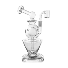 The MJ Arsenal Gemini Mini Dab Rig is a portable borosilicate glass rig with a spherical chamber, angled mouthpiece, quartz banger, and wide sturdy base, offering smooth lines and a modern design.