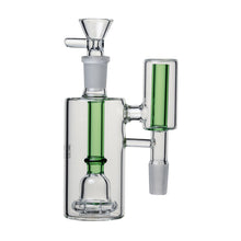 The Human Grade The Inverter Ash Catcher is a clear glass ash catcher with green accents, a cylindrical chamber, vertical percolator, and multiple joints. It enhances water filtration for any 14mm water pipe or smoking device.