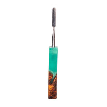 The MJ Arsenal Stabwood Dab Tool features a stainless steel sculpting tip and a textured handle crafted from turquoise resin blended with brown wood, shown isolated on a white background.