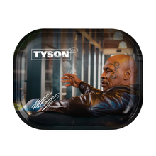The Tyson 2.0 Rolling Trays display Mike Tyson reclining and smoking, with "TYSON 2.0" text above and his white signature on the lower left. Designed for legal use, these trays are offered in multiple sizes.