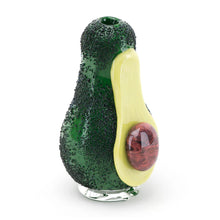 The Empire Glass Works Avocadope Peak Top features a textured dark green glass surface, a smooth yellow accent, and a round reddish-brown pit design on one side.