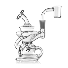 The MJ Arsenal Hydra Mini Dab Rig is a clear glass piece with intricate curved and twisted Klein recycler-inspired elements, a sturdy base, bent neck, and an overlapping M and Y logo on the main chamber.