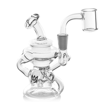 The MJ Arsenal Hydra Mini Dab Rig is a clear glass rig with a bent neck, circular base, attached quartz banger, and decorative logo on the body.
