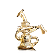 The MJ Arsenal Hydra Vape Edition is a transparent amber glass water pipe with multiple curved chambers, a tilted mouthpiece, and splash resistance. It features a black M logo on its base and is shown on a white background.