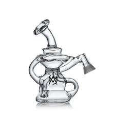 The MJ Arsenal Hydra Vape Edition is a clear glass water pipe with a twisted design, splash-resistant bubbler, side handle, angled mouthpiece, and a black MJ logo on the base. It stands on a reflective surface against a white background.