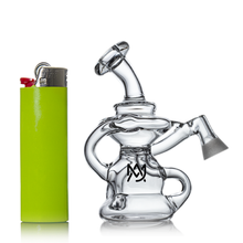 The MJ Arsenal Hydra Vape Edition, a small clear glass mini dab rig with curved elements and a front logo, is shown beside a bright green lighter on a white background.