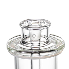 Close-up of a clear glass stopper fitted in the MJ Arsenal Piston Gravity Bong, showcasing its smooth, reflective borosilicate surface and disc percolation-inspired circular design details.