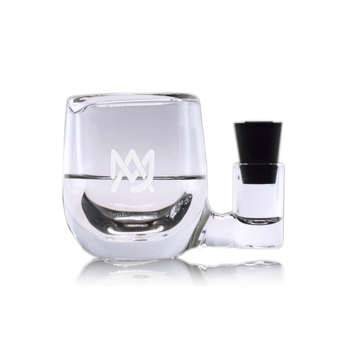 The MJ Arsenal ISO Station is a clear borosilicate glass mug featuring a white geometric logo, with an attached side chamber and black stopper—perfect for keeping your cleaning essentials organized.