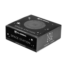 A black rectangular box labeled MJ Arsenal Space Station features star and constellation graphics, plus a circular glass accessory organizer illustration on the lid.