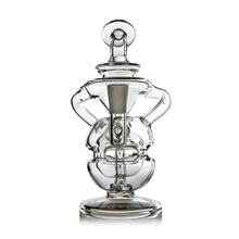 The MJ Arsenal Infinity Mini Dab Rig is a clear borosilicate glass rig with a wide base, dual handles, and symmetrical design. It features a fab egg percolator for smooth filtration and is set against a plain white background.