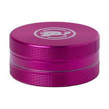 The BIGFUN! Medium 2pc Grinder is a metallic pink, round aluminum grinder with textured sides, a white stylized logo on top, and sharp diamond teeth, shown against a white background.