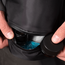 Close-up of hands opening the Puffco Journey Bag, revealing several small containers and a teal packet inside—the perfect way to organize all your Peak Pro accessories.