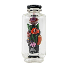 The Empire Glass Works Save the Seas Peak Top is a clear glass Puffco Peak attachment with a black lid, featuring colorful glass flowers, leaves, and a mushroom on a black base, plus glow-in-the-dark accents.