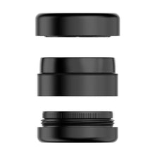 Three black cylindrical sections of the Flower Mill 2.5" Next Gen Premium Grinder, featuring mill plates, are stacked vertically with gaps between them against a white background, highlighting the grinder’s minimalist design.