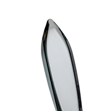 A stainless steel butter knife with a smooth, rounded blade rests beside the sleek MJ Arsenal Excalibur Dab Tool, both set against a white background.